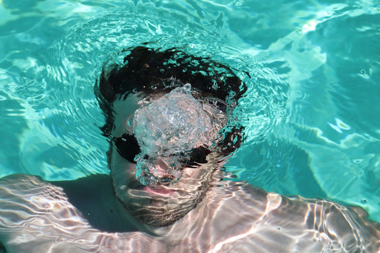 close up photo of man swimming underwater
