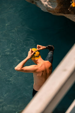 man in black shorts holding yellow and blue goggles