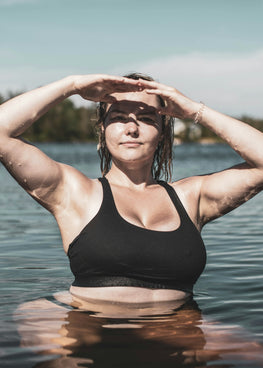 woman in black tank top standing on water during daytime