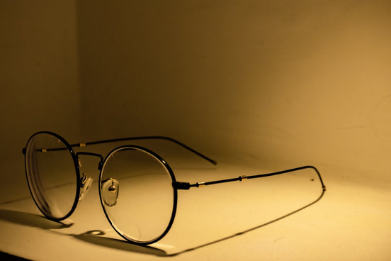 silver framed eyeglasses on white table