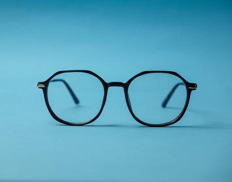 black framed eyeglasses on white surface