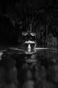 a black and white photo of a person wearing a mask and goggles