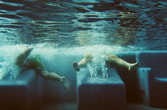 a couple of people that are swimming in some water