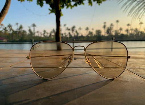 a pair of sunglasses sitting on a tiled floor