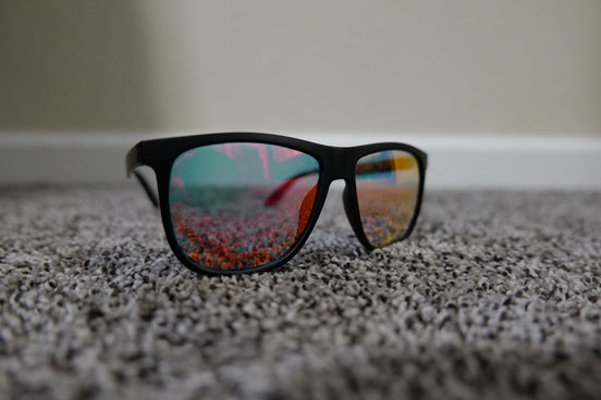 a pair of sunglasses on a beach