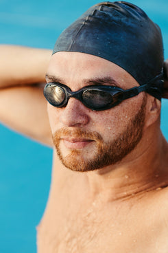 a man wearing a swimming cap and goggles