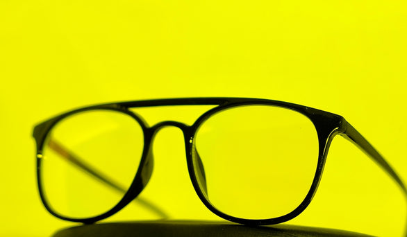 a pair of glasses sitting on top of a table