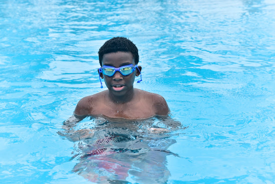 A man in a swimming pool wearing goggles